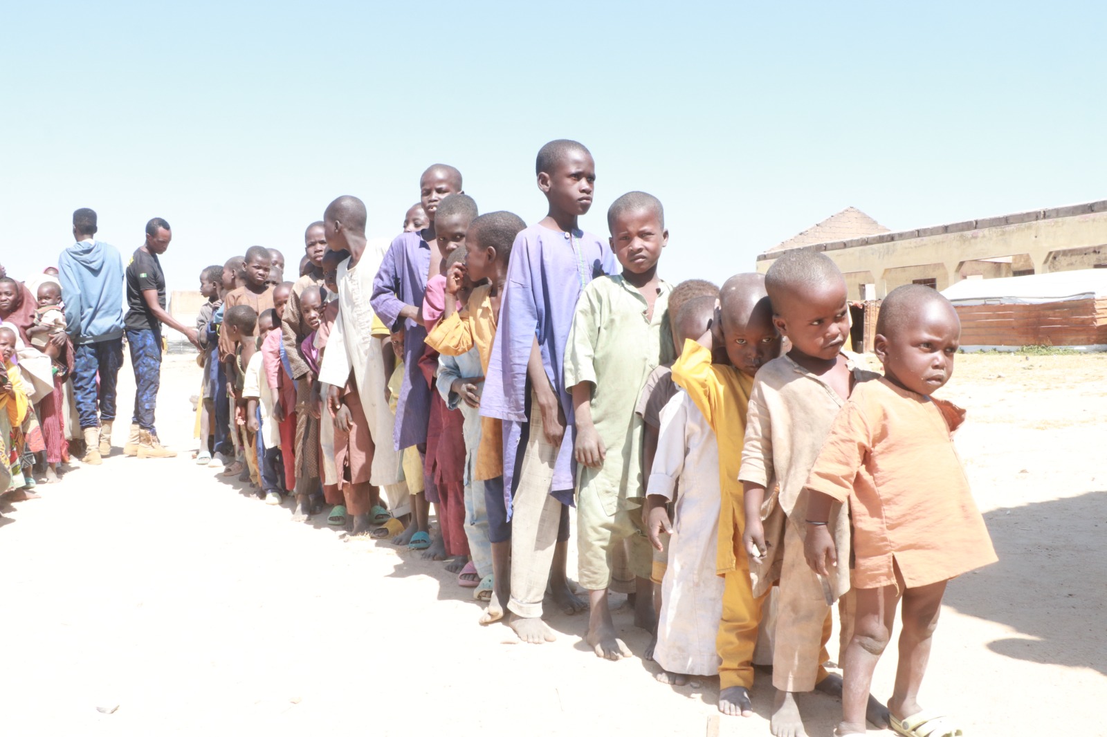 Children lined up at a Dar Al Ayetam Charity Foundation community event in Nigeria